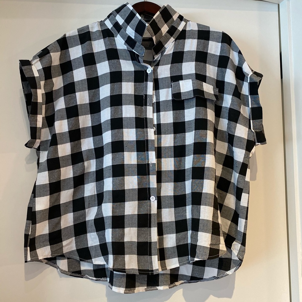 A black and white plaid shirt with short sleeves